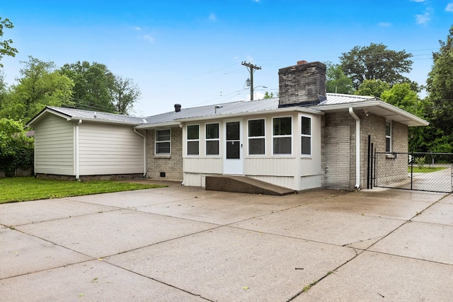 3103 Lakeland Dr, Nashville, TN 37214 - rear view of house with a gate, metal roof, a chimney, and driveway