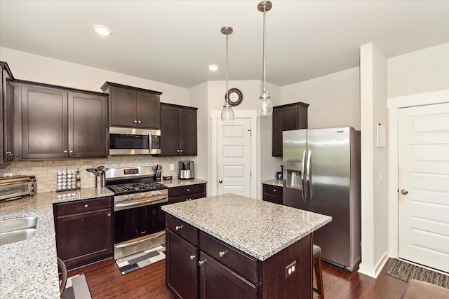 3157 Rift Ln, Murfreesboro, TN 37130 - kitchen featuring appliances with stainless steel finishes, dark wood finished floors, tasteful backsplash, dark brown cabinetry, and recessed lighting
