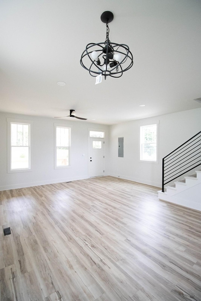 105 Shephard St N, Winchester, TN 37398 - unfurnished living room featuring stairway, a chandelier, electric panel, and light wood-type flooring