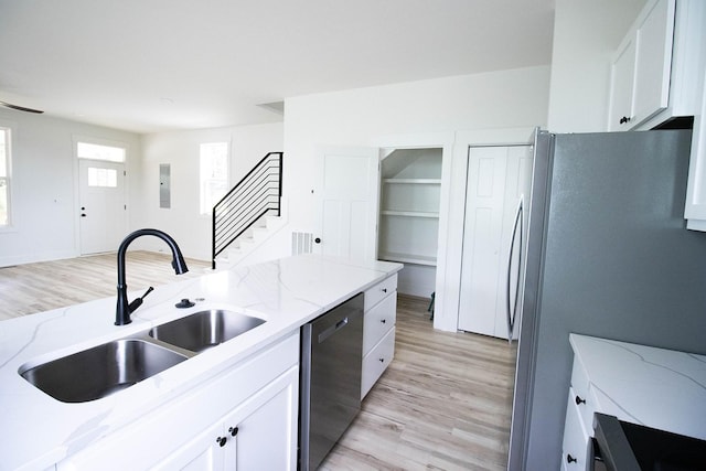 105 Shephard St N, Winchester, TN 37398 - kitchen with white cabinetry, light wood-style floors, stainless steel appliances, and a sink