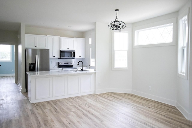 105 Shephard St N, Winchester, TN 37398 - kitchen with baseboards, an inviting chandelier, appliances with stainless steel finishes, and a sink