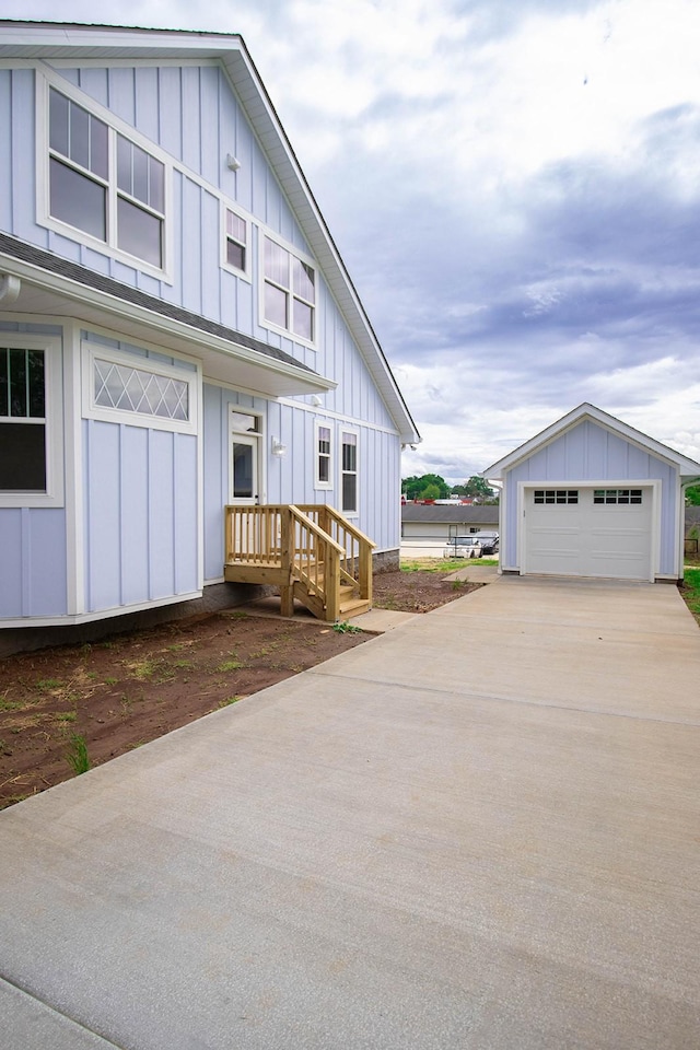 105 Shephard St N, Winchester, TN 37398 - modern farmhouse with a detached garage, driveway, an outdoor structure, and board and batten siding