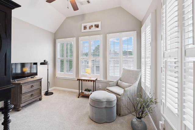 sitting room featuring carpet, visible vents, lofted ceiling, and a ceiling fan