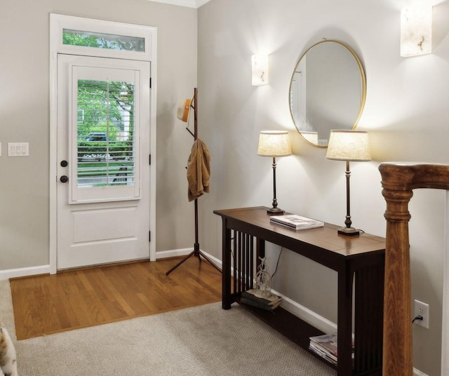 entryway with baseboards and wood finished floors