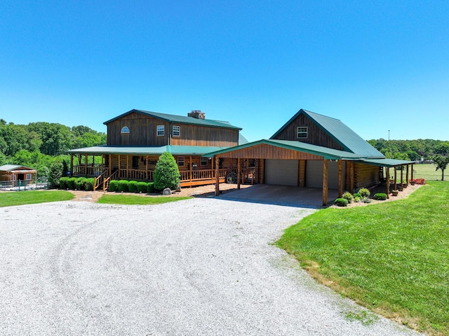 375 Good Hope Rd, Leoma, TN 38468 - cabin with driveway, a garage, a carport, a front yard, and a porch