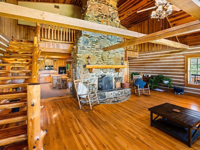375 Good Hope Rd, Leoma, TN 38468 - living area featuring hardwood / wood-style flooring, a fireplace, high vaulted ceiling, and a chandelier