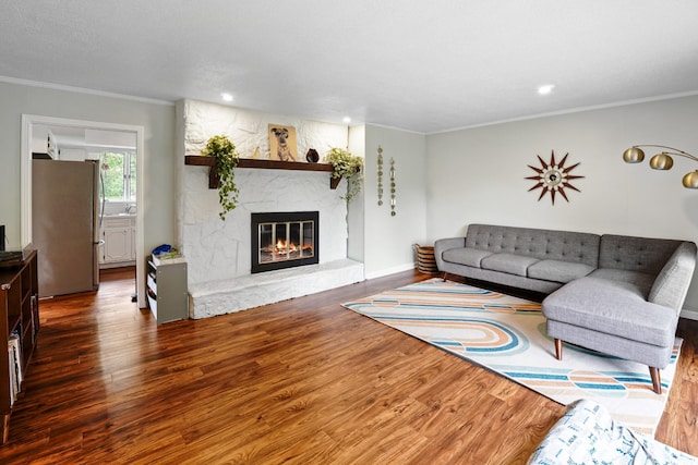 5024 Lakeridge Dr, Old Hickory, TN 37138 - living area featuring wood finished floors, ornamental molding, a stone fireplace, recessed lighting, and baseboards