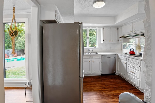 5024 Lakeridge Dr, Old Hickory, TN 37138 - kitchen with appliances with stainless steel finishes, under cabinet range hood, a textured ceiling, healthy amount of natural light, and dark wood-style floors