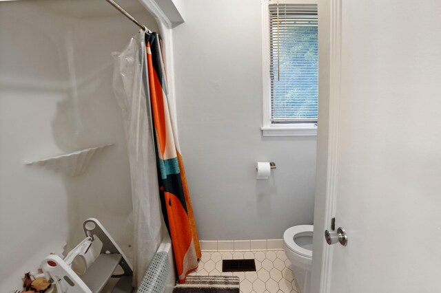 5024 Lakeridge Dr, Old Hickory, TN 37138 - full bathroom with plenty of natural light, toilet, curtained shower, and tile patterned flooring