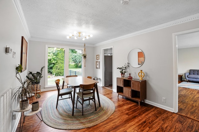 5024 Lakeridge Dr, Old Hickory, TN 37138 - dining room with a chandelier, a textured ceiling, ornamental molding, dark wood-type flooring, and baseboards