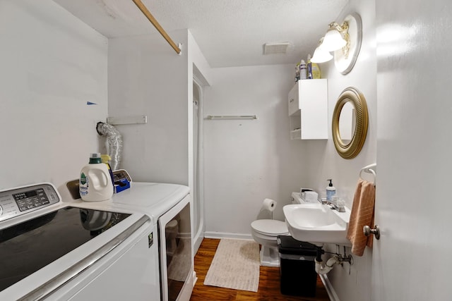 5024 Lakeridge Dr, Old Hickory, TN 37138 - bathroom featuring washing machine and dryer, wood finished floors, a sink, baseboards, and toilet