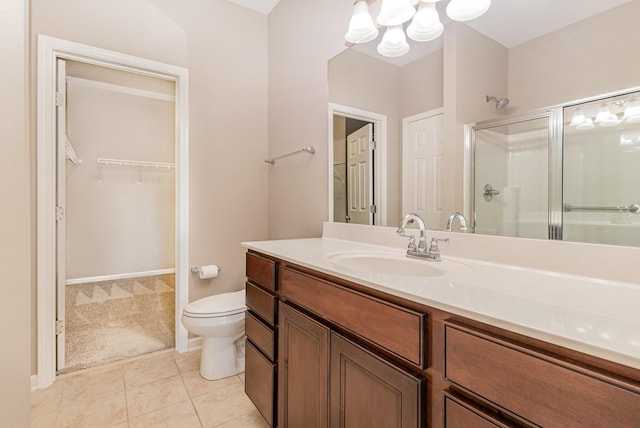 full bath featuring an inviting chandelier, toilet, a stall shower, tile patterned floors, and vanity