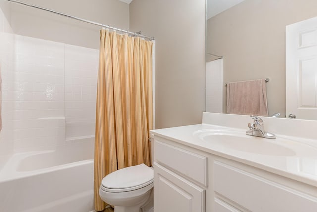 bathroom with vanity, toilet, and shower / tub combo