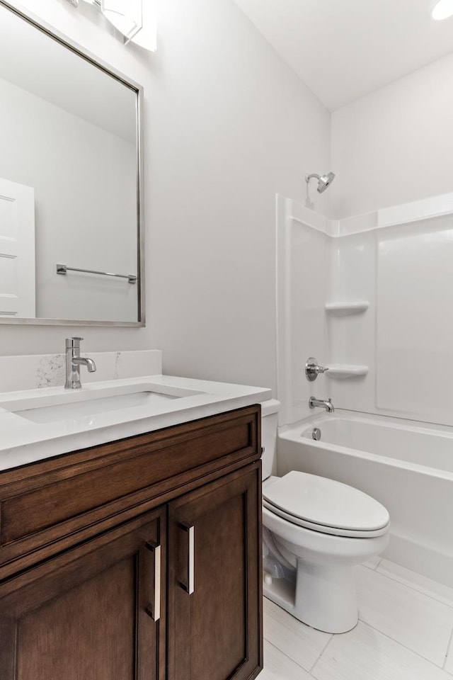 bathroom with tile patterned floors, toilet, vanity, and washtub / shower combination