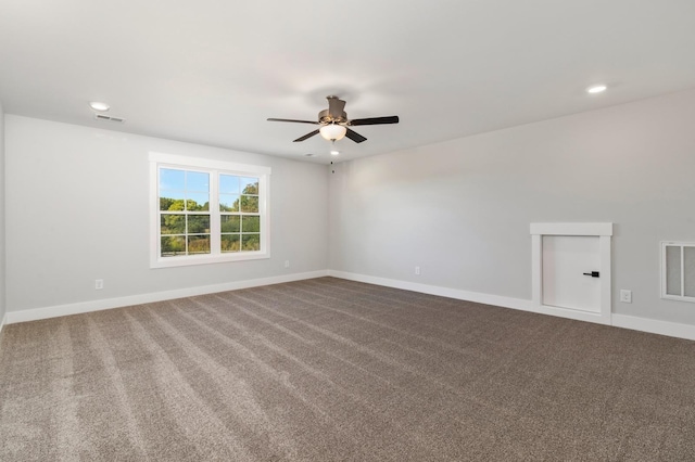 unfurnished room with dark colored carpet, a ceiling fan, visible vents, and recessed lighting