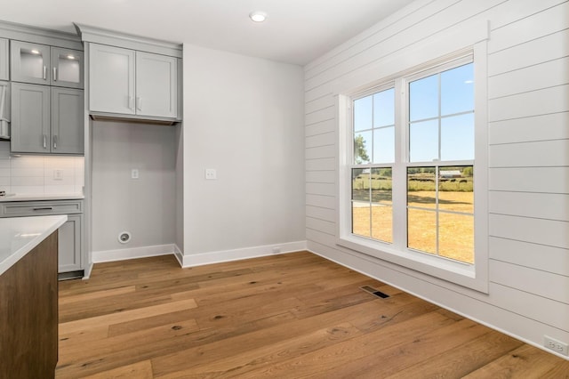 unfurnished dining area with baseboards, recessed lighting, visible vents, and light wood-type flooring