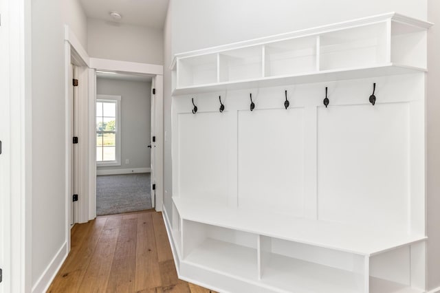 mudroom featuring baseboards and light wood-style floors