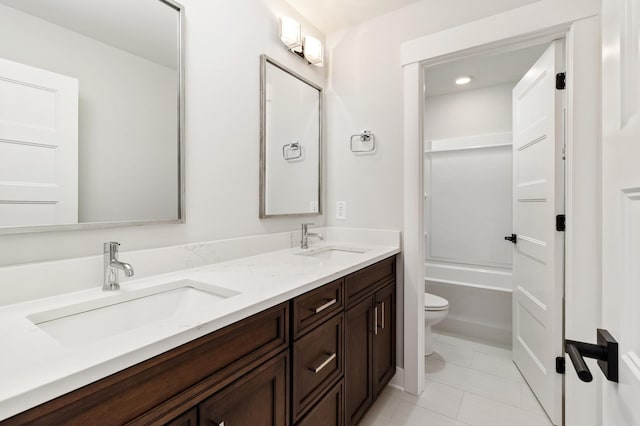 full bathroom with toilet, tile patterned flooring, double vanity, and a sink