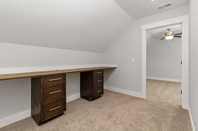 unfurnished office with lofted ceiling, baseboards, ceiling fan, visible vents, and light carpet