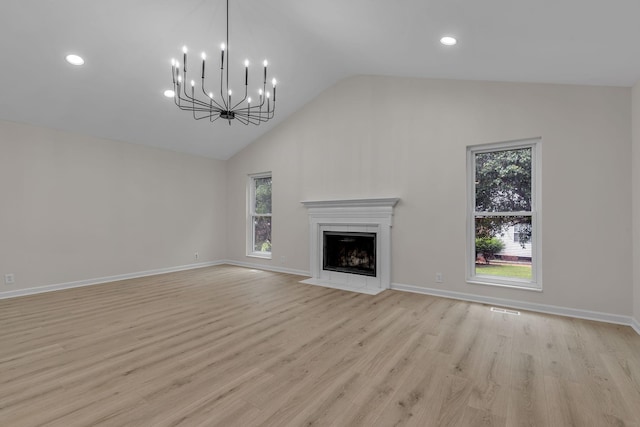 4048 Lancashire Dr, Antioch, TN 37013 - unfurnished living room with healthy amount of natural light, high vaulted ceiling, a fireplace with flush hearth, light wood-style flooring, and recessed lighting