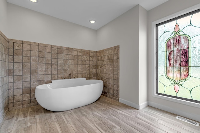 4048 Lancashire Dr, Antioch, TN 37013 - full bathroom featuring a freestanding tub, wood tiled floors, recessed lighting, and baseboards