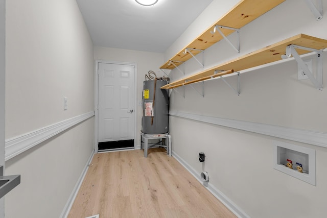 4048 Lancashire Dr, Antioch, TN 37013 - washroom with water heater, hookup for a washing machine, light wood finished floors, and baseboards