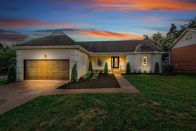 4048 Lancashire Dr, Antioch, TN 37013 - ranch-style house featuring stucco siding, driveway, covered porch, an attached garage, and a front yard