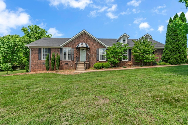 view of front facade featuring brick siding and a front lawn