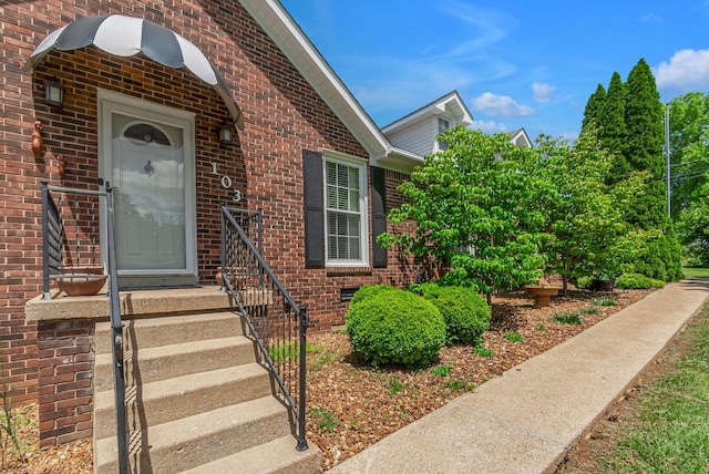 property entrance with brick siding