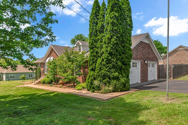 view of front of house with brick siding, a shingled roof, and a detached garage