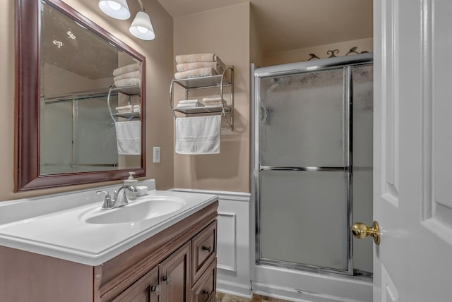 bathroom with a stall shower and vanity