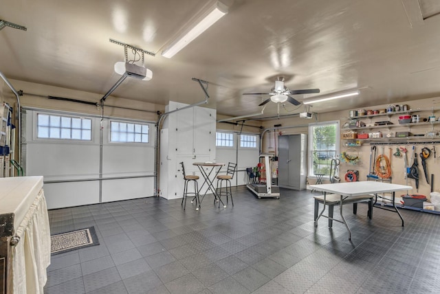 garage featuring a garage door opener and ceiling fan