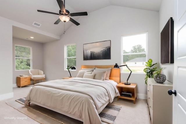bedroom with vaulted ceiling, light colored carpet, baseboards, and visible vents