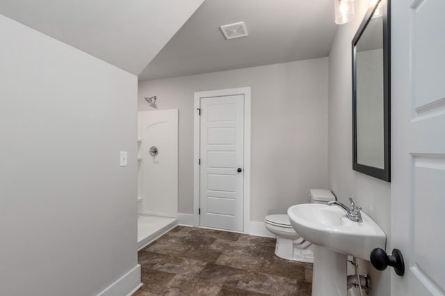 full bathroom featuring toilet, visible vents, baseboards, and a walk in shower