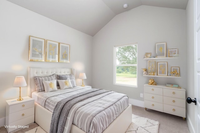 carpeted bedroom featuring lofted ceiling and baseboards
