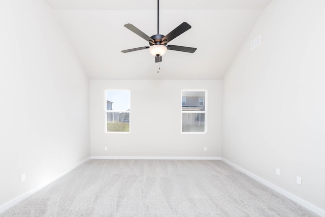 empty room with baseboards, ceiling fan, carpet, and vaulted ceiling