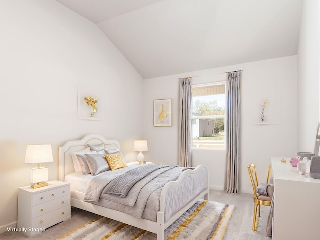 bedroom featuring lofted ceiling and light colored carpet