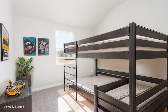 bedroom with carpet, vaulted ceiling, and baseboards