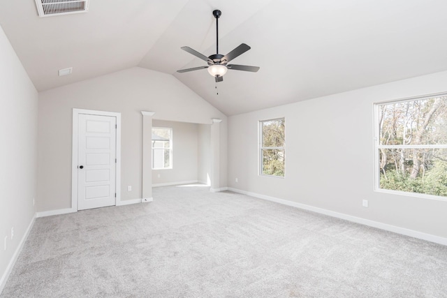 interior space with lofted ceiling, carpet flooring, visible vents, and baseboards