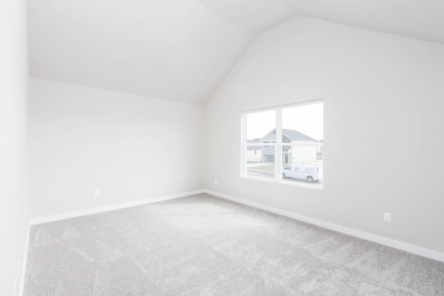 bonus room with lofted ceiling, carpet flooring, and baseboards