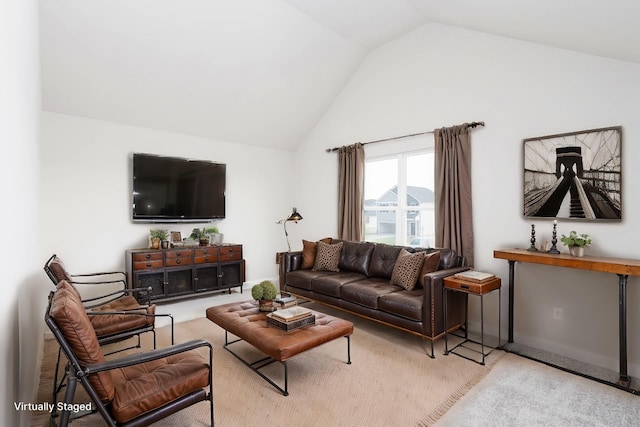 living area with vaulted ceiling and carpet