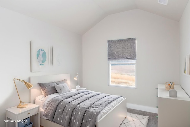 carpeted bedroom with baseboards, visible vents, and vaulted ceiling