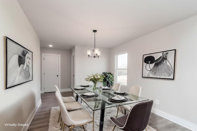 dining area with wood finished floors, a chandelier, baseboards, and recessed lighting