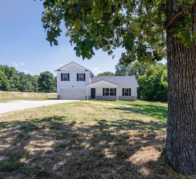 tri-level home with a front lawn, concrete driveway, and a garage
