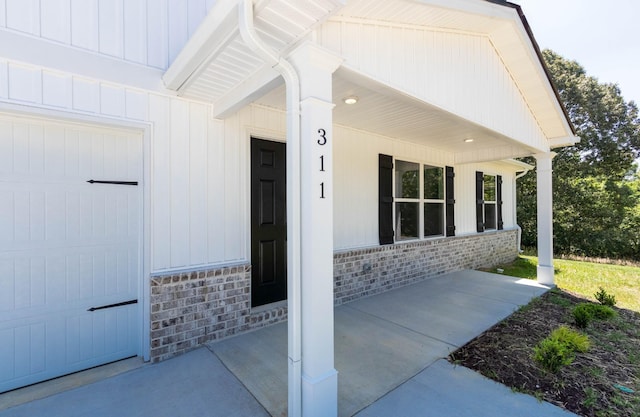view of exterior entry featuring stone siding and a porch