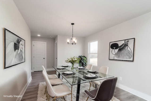 dining room with recessed lighting, wood finished floors, baseboards, and a notable chandelier