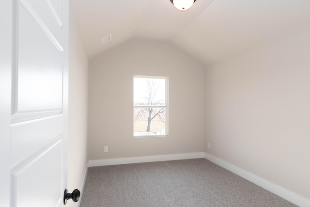 bonus room featuring carpet flooring, visible vents, baseboards, and lofted ceiling