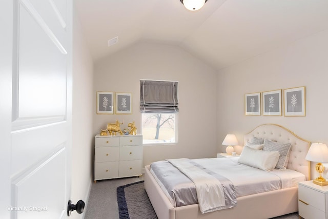 carpeted bedroom featuring lofted ceiling