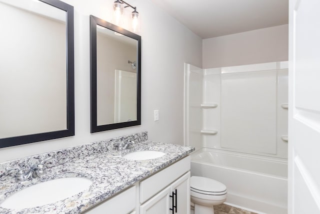 full bathroom with a sink, double vanity, toilet, and shower / bathtub combination