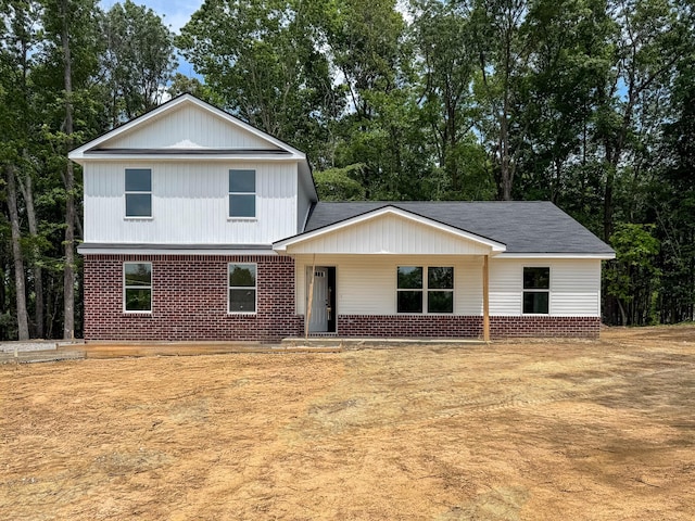 21 Woodland Farms, Dickson, TN 37055 - view of front of property featuring brick siding, covered porch, a shingled roof, and view of wooded area